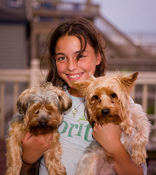 Girl with two puppies
